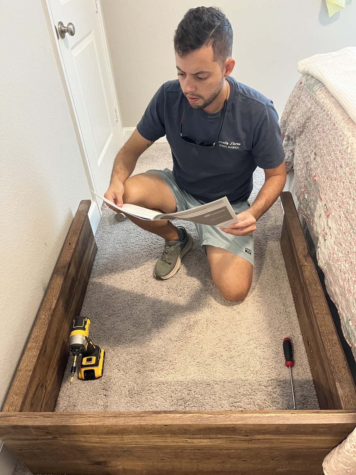 Paul reviewing the manufacturer instructions while assembling a bookcase